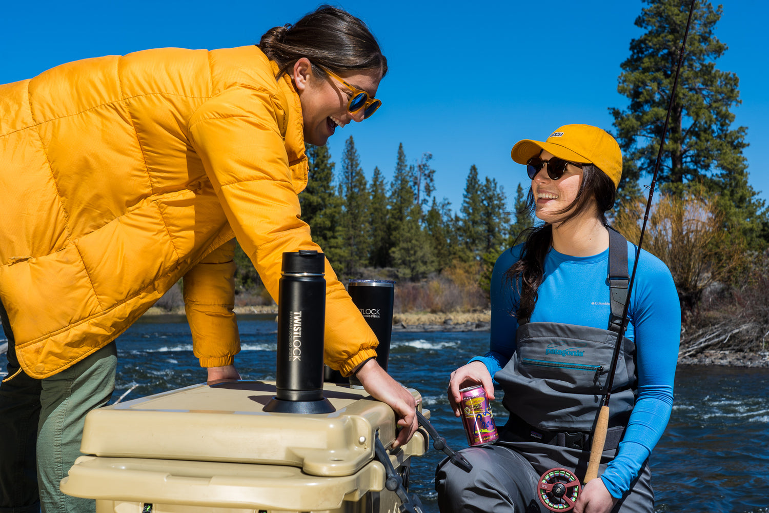 Two women by the river with a cooler and the coolest drinkware. Ever.