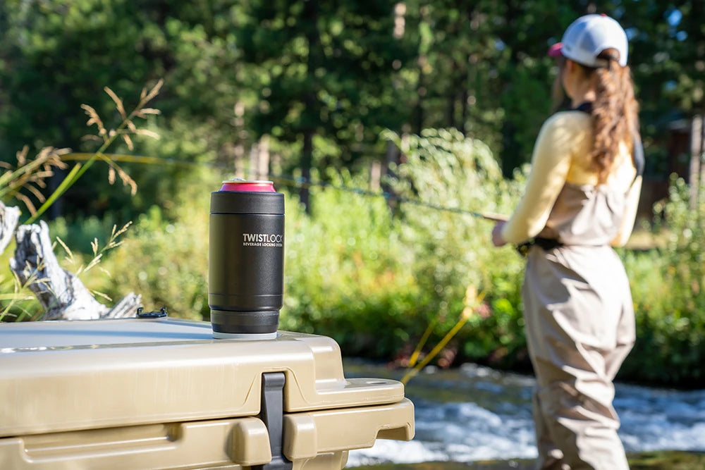 Can Cooler locked into a TwistLock Mini Disc on a cooler while a women fly fishes in a river.