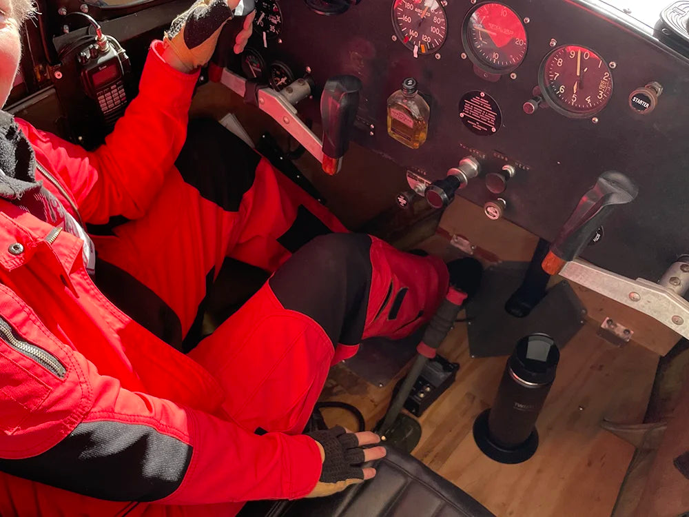 Cockpit of an airplane with the attachable secure flat mount locking cup holder on the floor with a TwistLock canteen locked in.