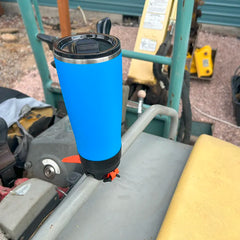 Crater Lake Blue TwistLock insulated 22oz Tumbler attached to a bar mount attachable cup holder on an excavator grab handle.