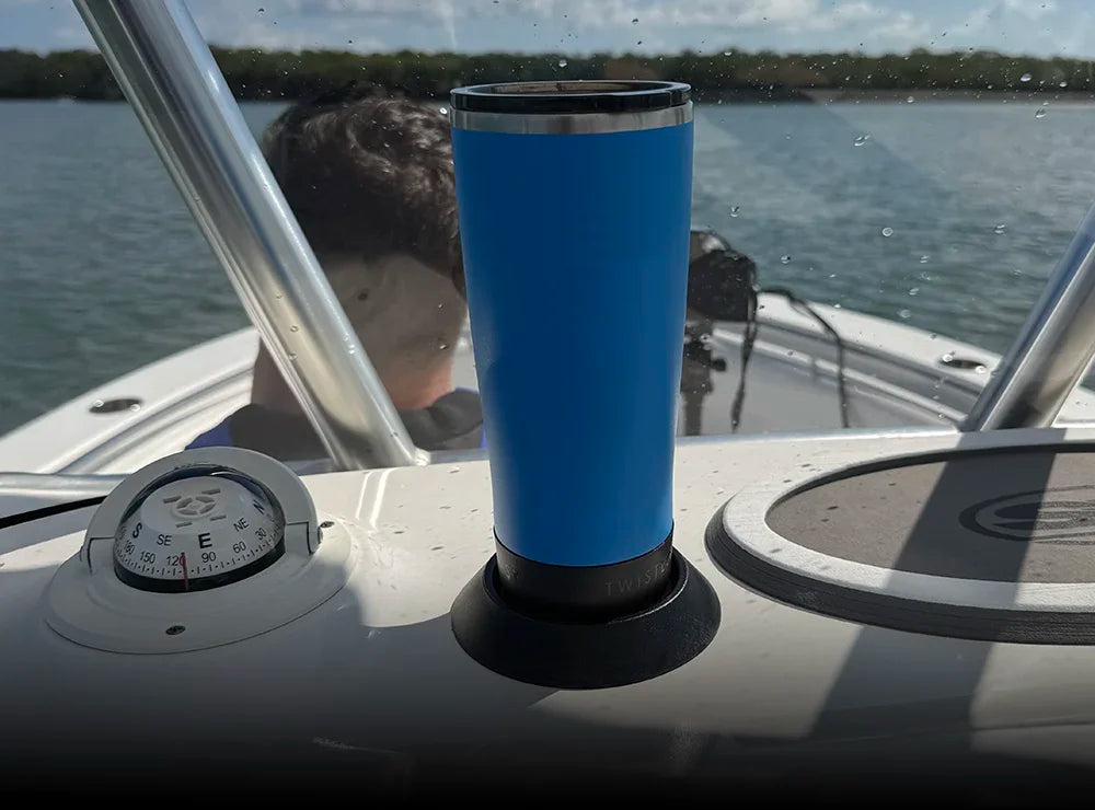 TwistLock Flat Mount secure locking cup holder attached to a boat with a blue insulated tumbler attached to it.