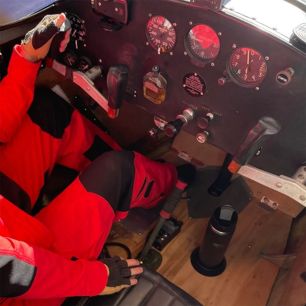 Insulated canteen and flat mount locking cup holder in a cockpit of an airplane.