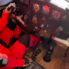 Insulated canteen and flat mount locking cup holder in a cockpit of an airplane.