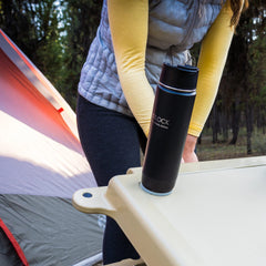 Camper opening their cooler with the insulated canteen beverage container securely attached to the lid.