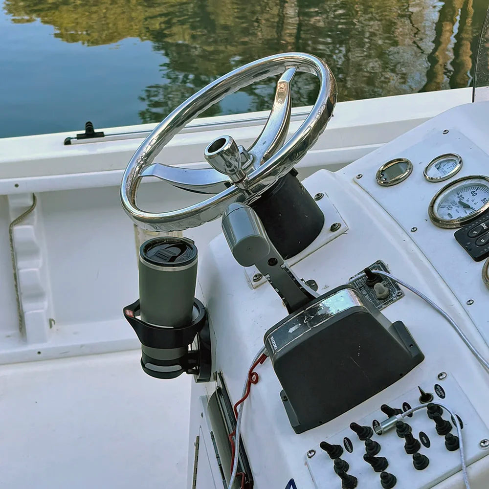 The TwistLock Folding Vertically Mounted Locking Cup Holder and 22oz Insulated Trailhead Green Tumbler on a Center Console Boat.