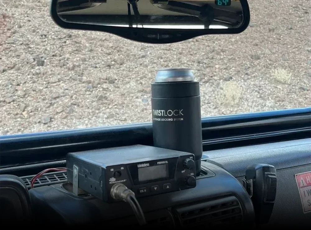 TwistLock Mini Disc Locking Cup Holder attached to the dash of a service truck with an insulated 12oz can cooler with it.