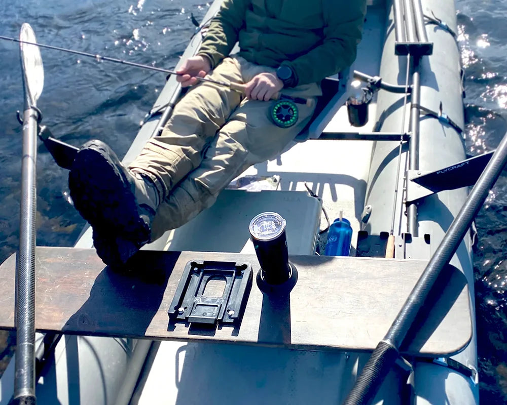 A fisher on a boat with his secure cup holder and insulated tumbler.