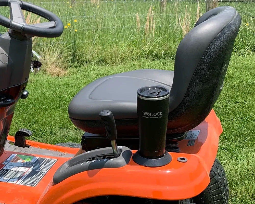 Tractor and locking cup holder with an insulated tumbler attached in.