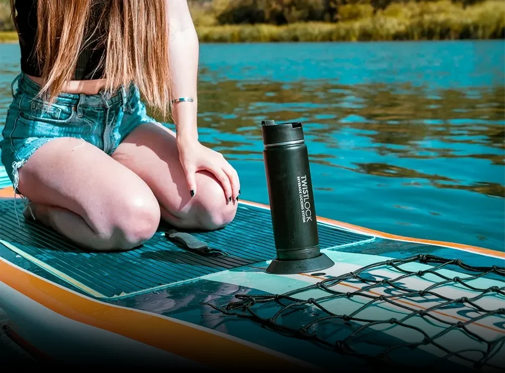 TwistLock Flat Mount secure locking cup holder attached to a paddleboard using the included adhesive.