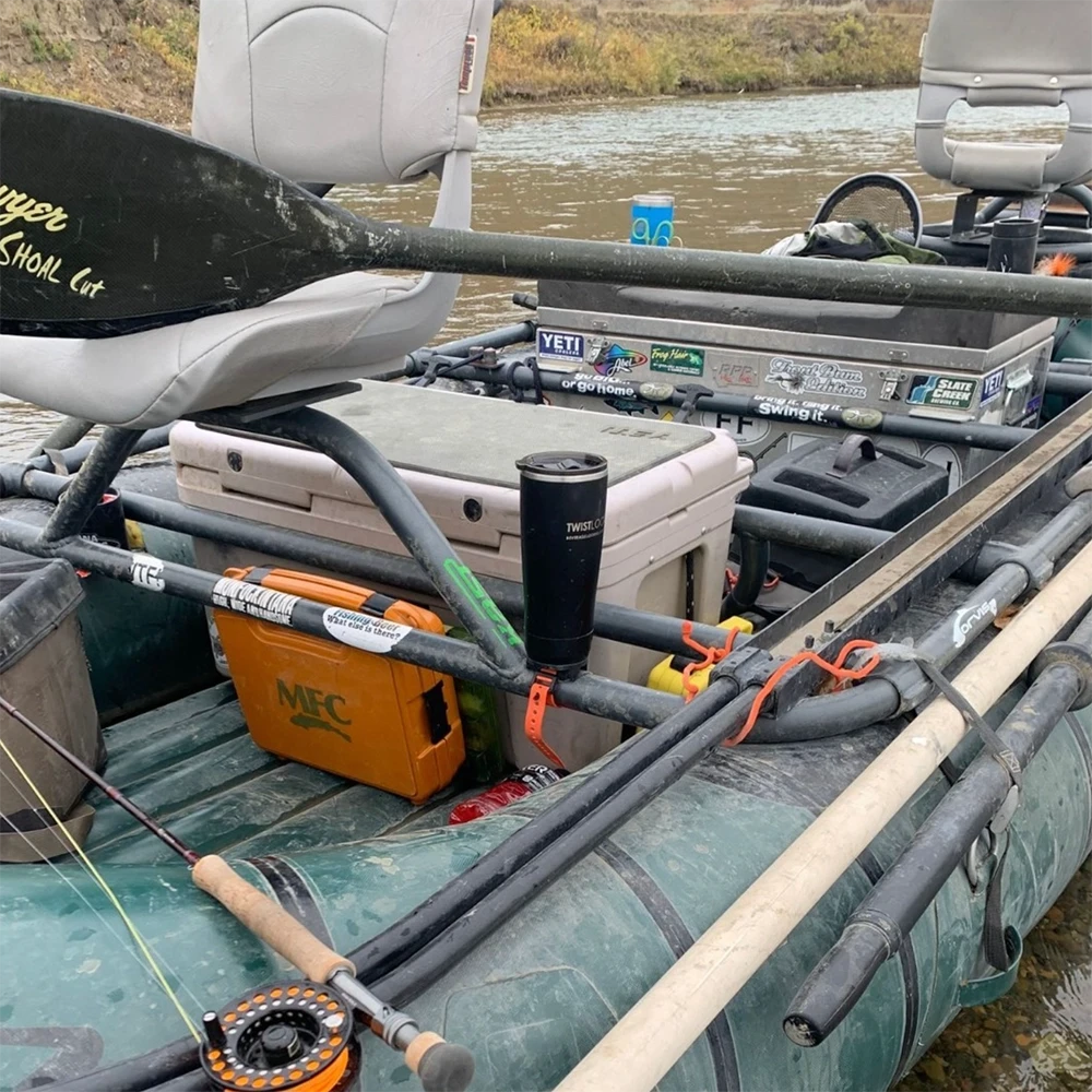 Removable bar mounted cup holder and tumbler attached to a fishing raft frame.