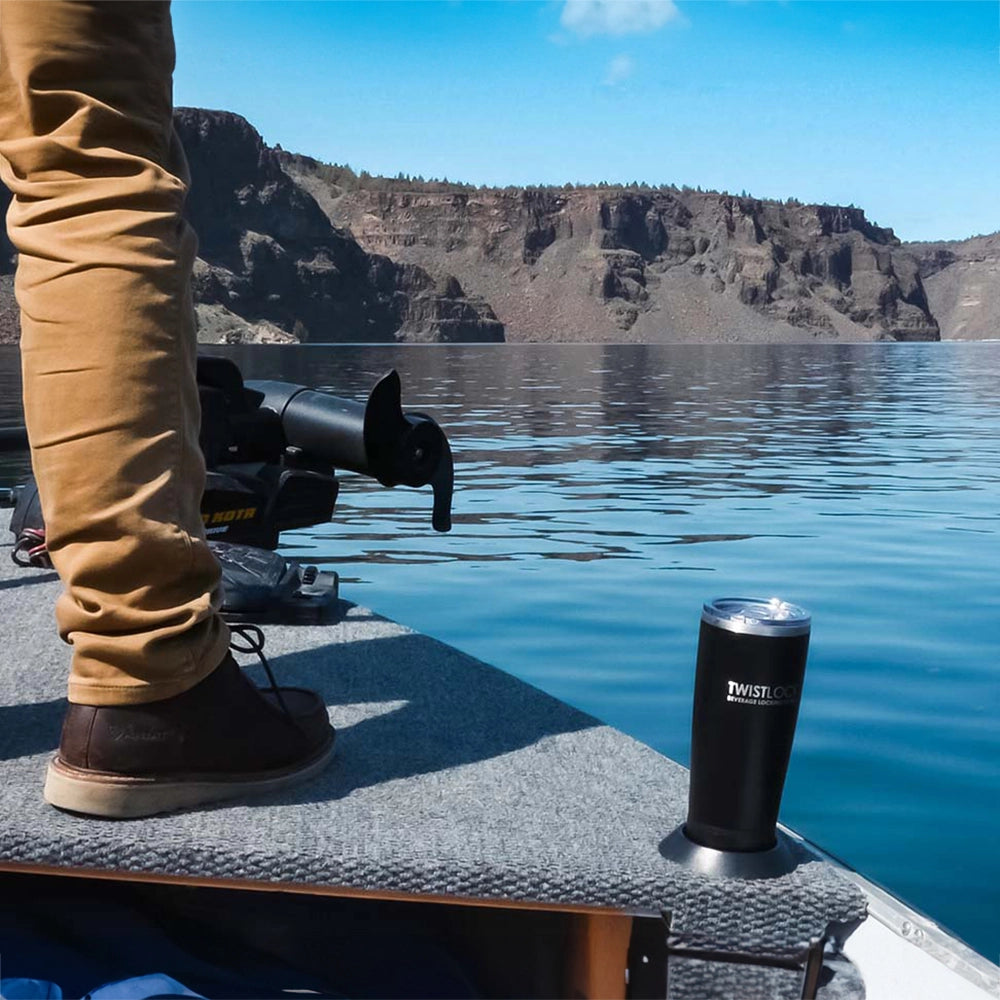 Attachable flat mount locking cup holder and tumbler on a fishing boat by the trolling motor.