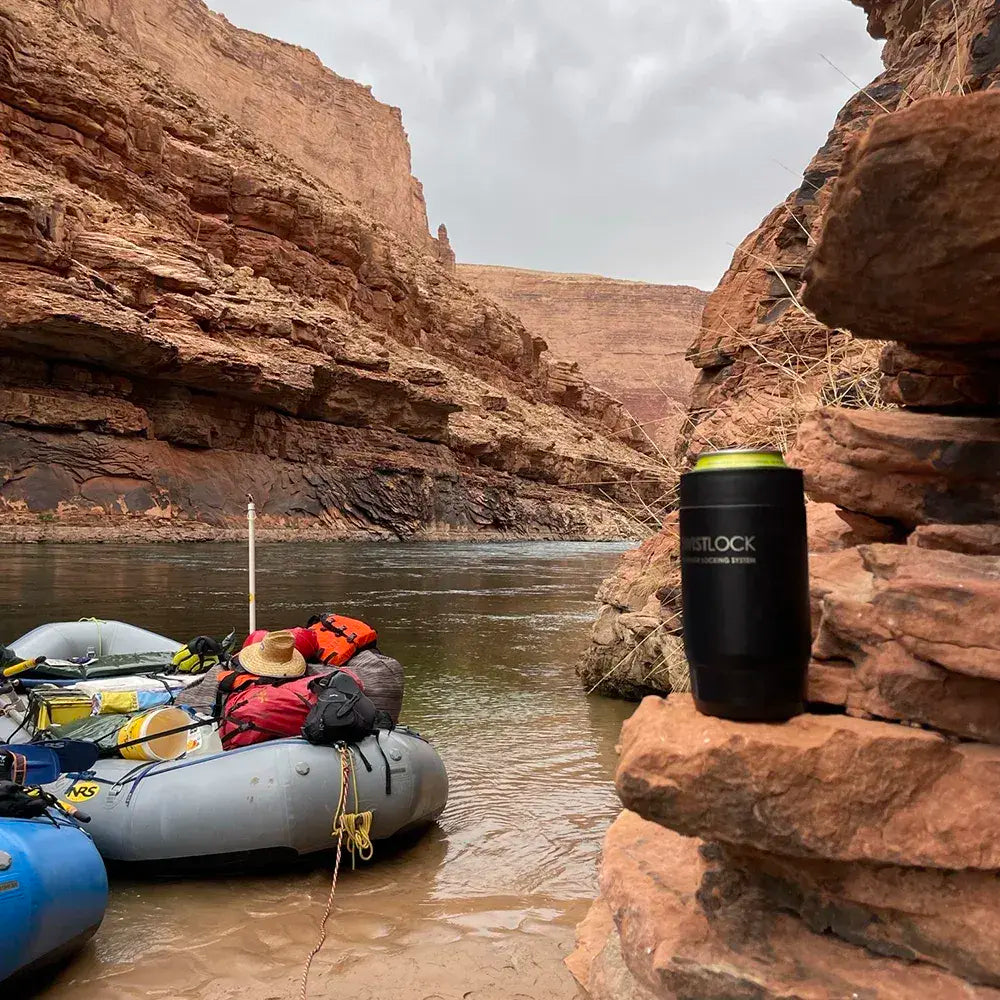 The grand canyon with an insulated can cooler sitting on the edge of the cliff during a raft trip.