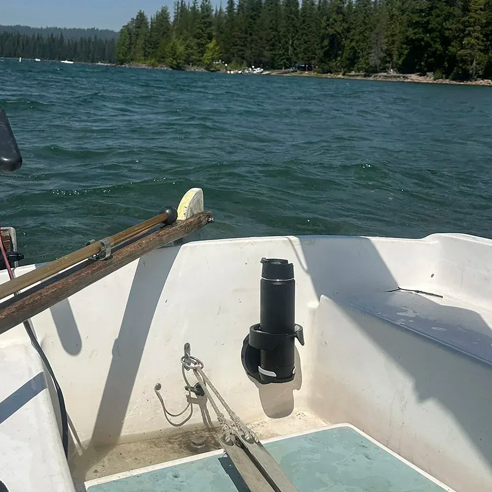 The TwistLock Vertical Mount Cup Holder attached to the transom of a small daysailer sailboat with an insulated canteen securely lock in.