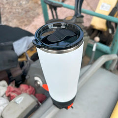 Summit White TwistLock insulated 22oz Tumbler attached to a bar mount attachable cup holder on an excavator grab handle.