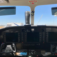 An insulated tumbler attached to a secure locking flat mount cup holder in the cockpit of an airplane.