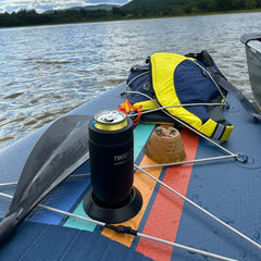 paddle board with an insulated can cooler and locking cup holder attached.