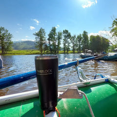 Raft frame locking cup holder with insulated tumbler attached to the side.