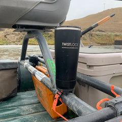 Fishing raft with a locking cup holder attached to the frame. Secured to the cup holder is a double-wall vacuum insulated tumbler.