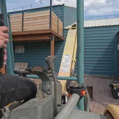 Showing a TwistLock Canteen and flat mount locking cup holder being used on an excavator grab handle.