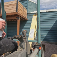 A summit white TwistLock tumbler being lock in and out of a bar mount locking cup holder attached to an excavator grab handle.