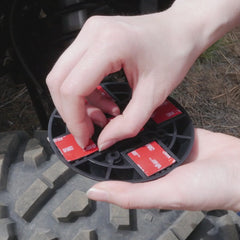 Installing a flat mount locking cup holder using the included adhesive squares.