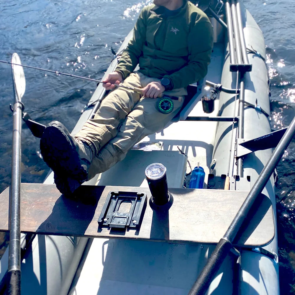 Fisher on raft with insulated tumbler attached to a locking cup holder on the seat.