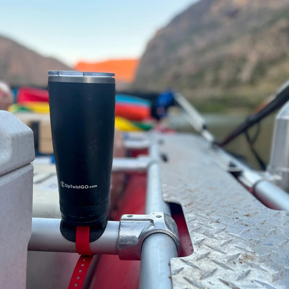 Raft frame cup holder attached with a locking insulated tumbler secured into it.