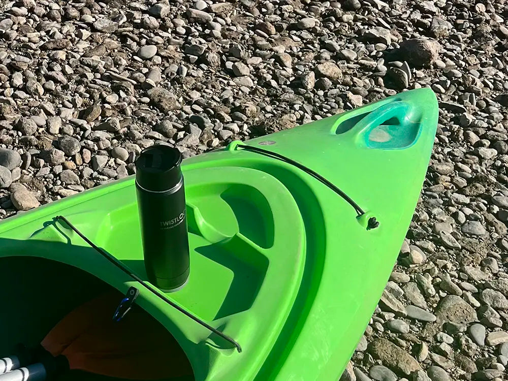 Attachable locking, secure cup holder on a kayak with a insulated canteen attached into it.