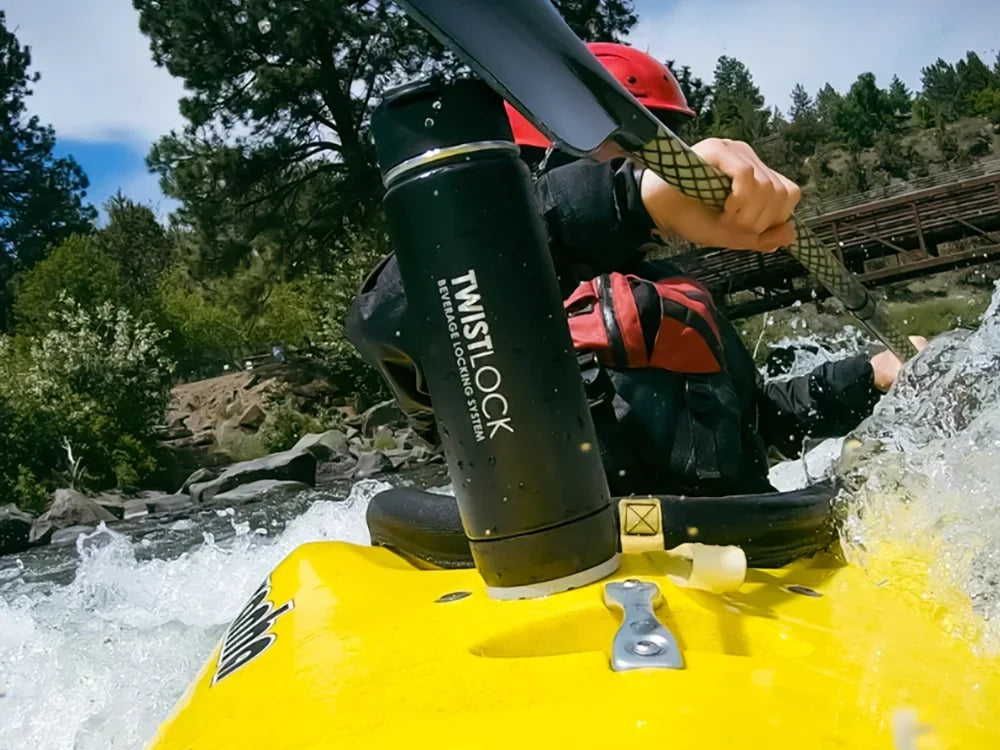 Attachable cup holder on kayak with insulated canteen secured in.